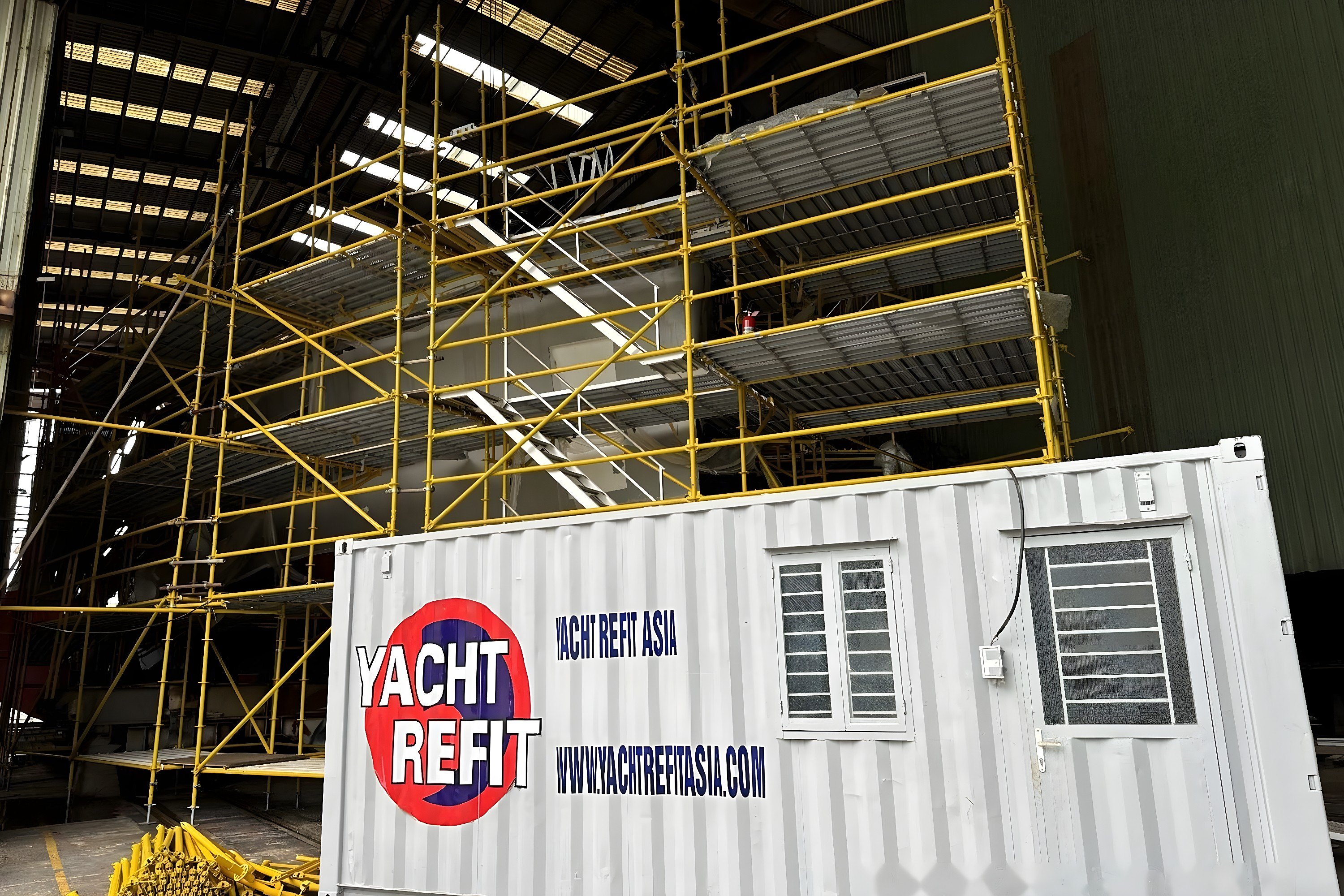 Site container beside three 33 m newbuilds in Haiphong, Vietnam