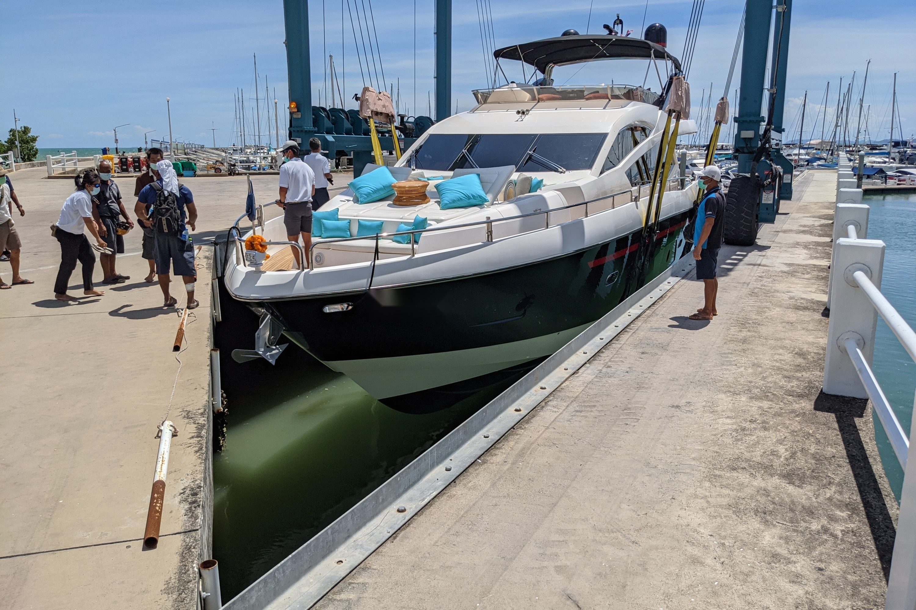Black hull with a red style line on a motor yacht alongside a dock